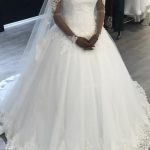 Enchanting Ball Gown Off Shoulder Long Sleeve Court Tulle Wedding Dress with Lace Embellishments