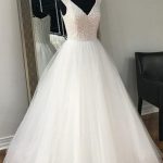 Exquisite A-Line Tulle Wedding Dress with Beading V-Neck and Sleeveless Design