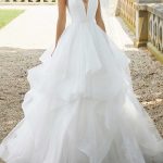 Ball Gown with V-Neckline and Sweep Brush Train crafted from Organza with a Backless Design