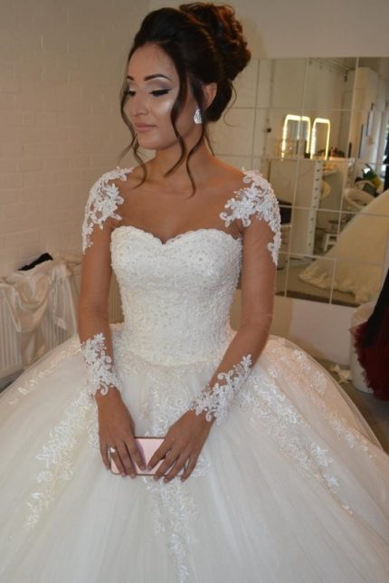 Ivory Lace Appliques Wedding Dress with Sheer Long Sleeves creating a Pretty Look