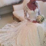 Ivory Lace Wedding Dress with Chapel Length Sleeves and Scalloped Neckline adorned with Buttons