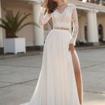 Elegant White Cut Out A-Line Split Lace Bridal Gown with V-Neck and Long Sleeves